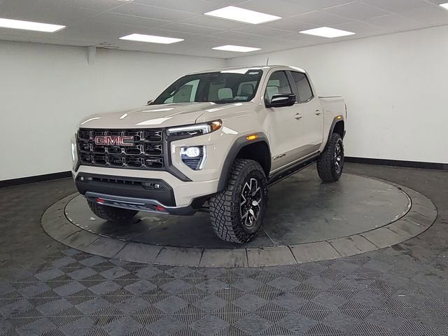 2026 GMC Canyon AT4X in Coastal Dune — front three-quarter view